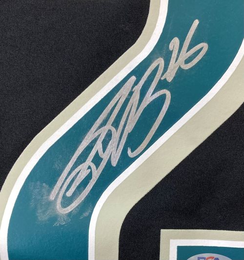 Close-up of a Saquon Barkley Signed Eagles Super Bowl 59 LIX Black Nike Jersey by Sports Integrity, showing a large number 2 with white and teal border. Number is signed in silver marker with "26" written above the signature. PSA 3C89561.