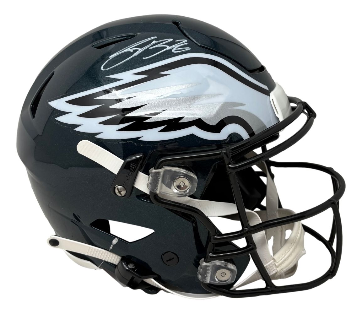 The Saquon Barkley Signed Philadelphia Eagles FS Authentic SpeedFlex Helmet by Sports Integrity features the team’s wing logo, a white autograph on top, dark green shell, black facemask, and a white chin strap. PSA/DNA authenticated.