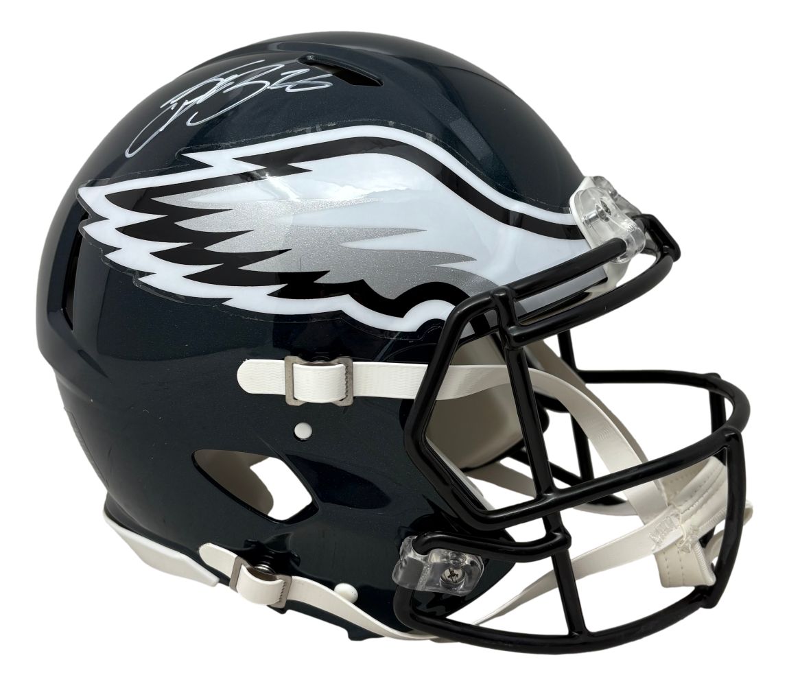 The Sports Integrity Saquon Barkley Signed Philadelphia Eagles FS Authentic Speed Helmet features a dark green shell with white and silver eagle wing logo, white facemask, and Saquon Barkley’s autograph authenticated by PSA/DNA.