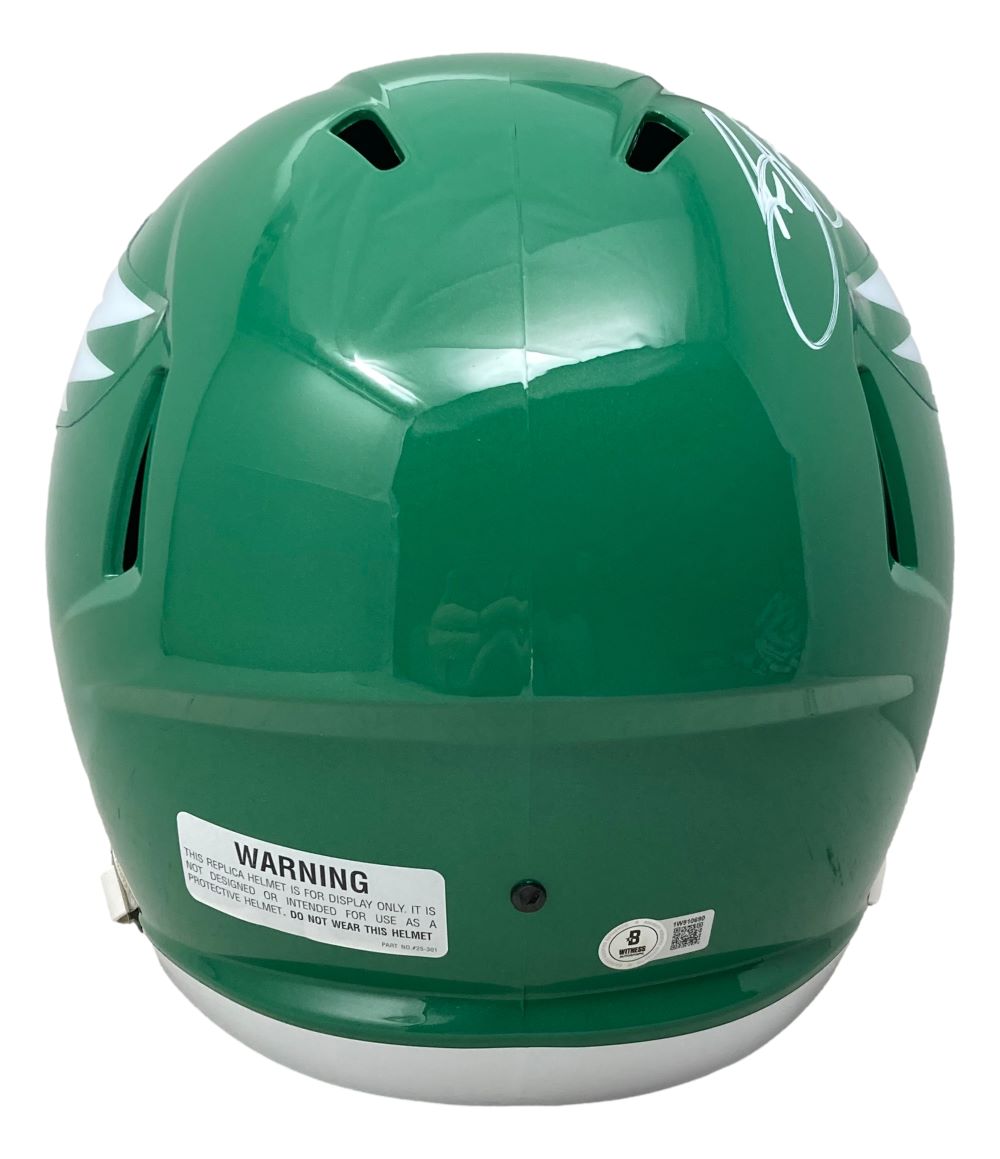 The Saquon Barkley Signed Eagles FS Kelly Green Replica Speed Helmet by Sports Integrity displays a white warning label, multiple vents, and Barkley's signature on the upper right side. Includes BAS authentication and display case.