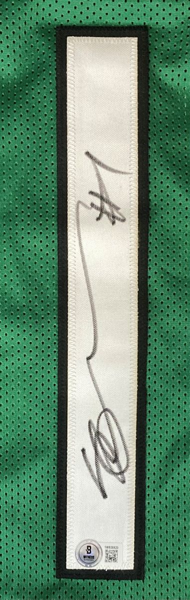 The Ahmad Sauce Gardner New York Signed Green Football Jersey by Sports Integrity features green mesh fabric, a white rectangular patch with black trim, a bold black autograph, and an authentication sticker with a QR code.