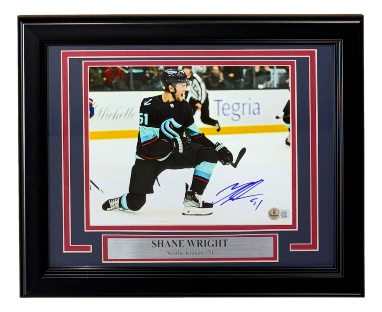 The Sports Integrity Shane Wright Signed Framed 8x10 Seattle Kraken Photo (BAS) features player #51 celebrating on the ice, complete with a silver nameplate beneath the image.