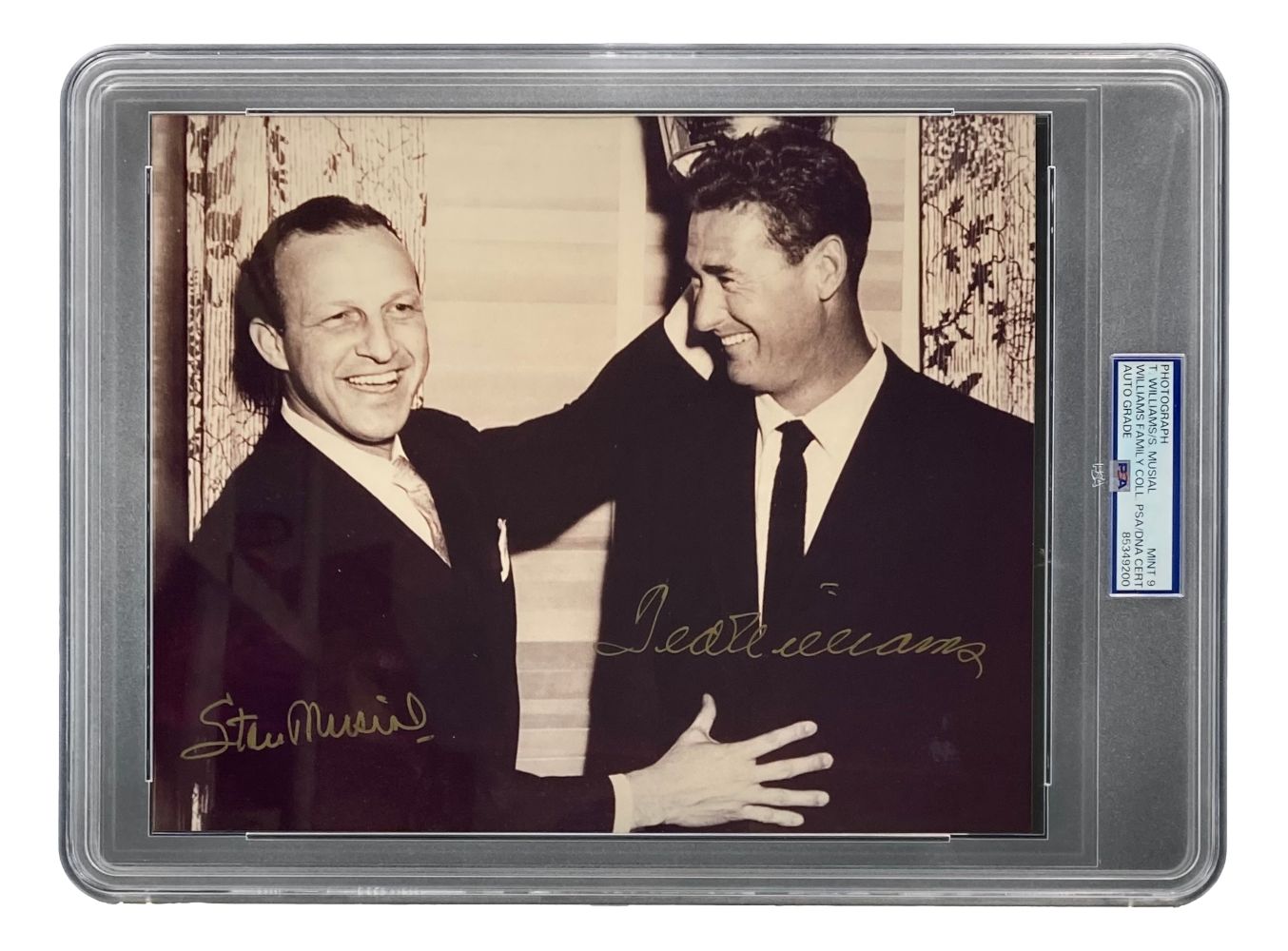 The Sports Integrity Ted Williams Stan Musial Signed Slabbed 8x10 Photo features both legends greeting indoors. Sepia-toned, autographed by both, graded PSA Mint 9, and encased with a certification label for authenticity.