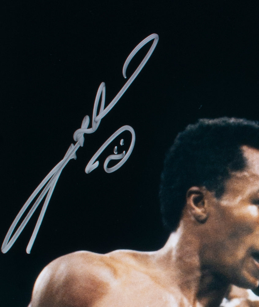 Close-up of a Sugar Ray Leonard Signed 16x20 Boxing Photo by Sports Integrity, featuring the upper body of the athlete in motion against a dark background, with a bold silver autograph at the top left.