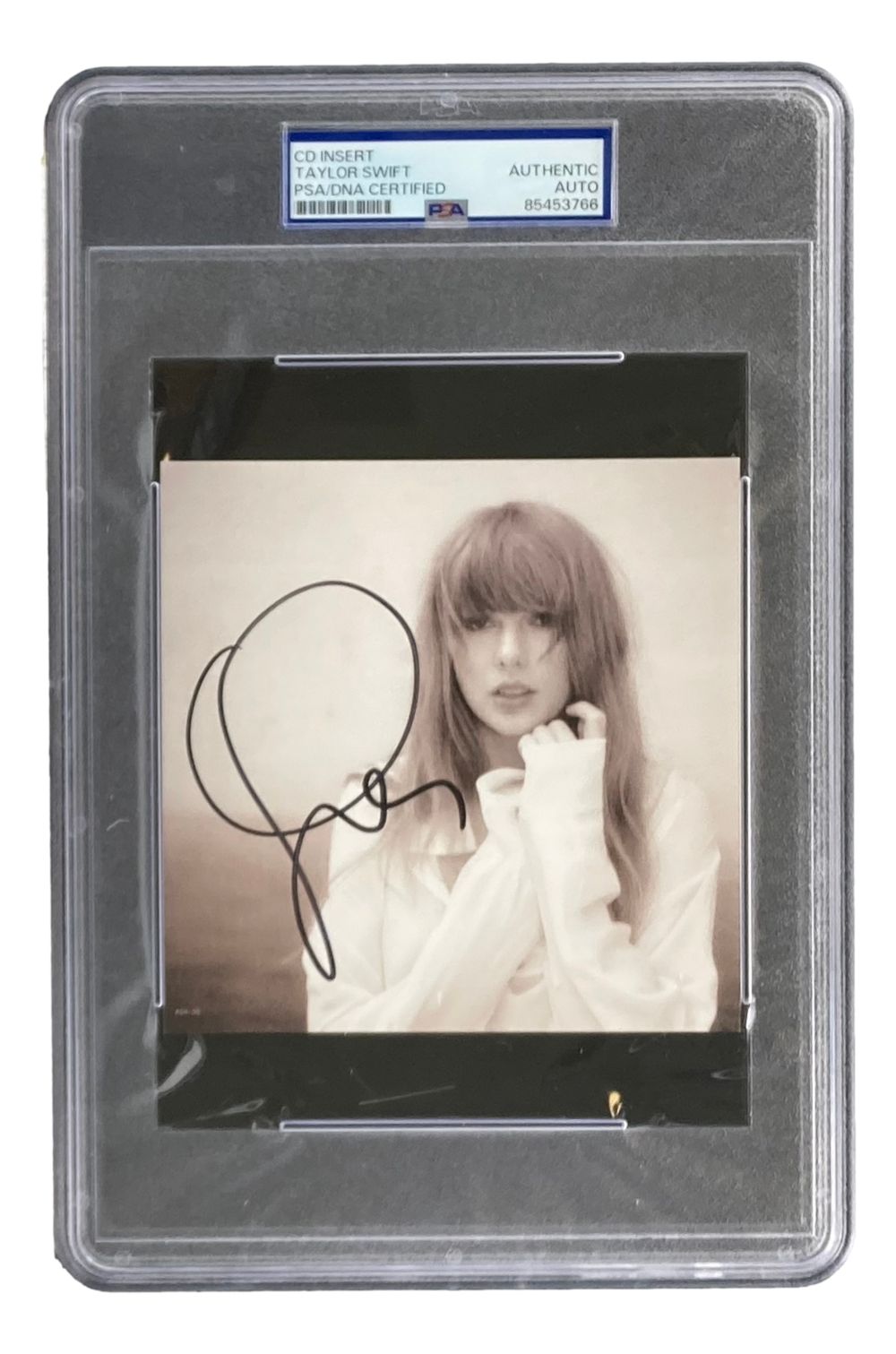 A Taylor Swift signed "The Tortured Poets Department" CD insert by Sports Integrity, PSA graded. Taylor poses in a light outfit with one hand near her face.