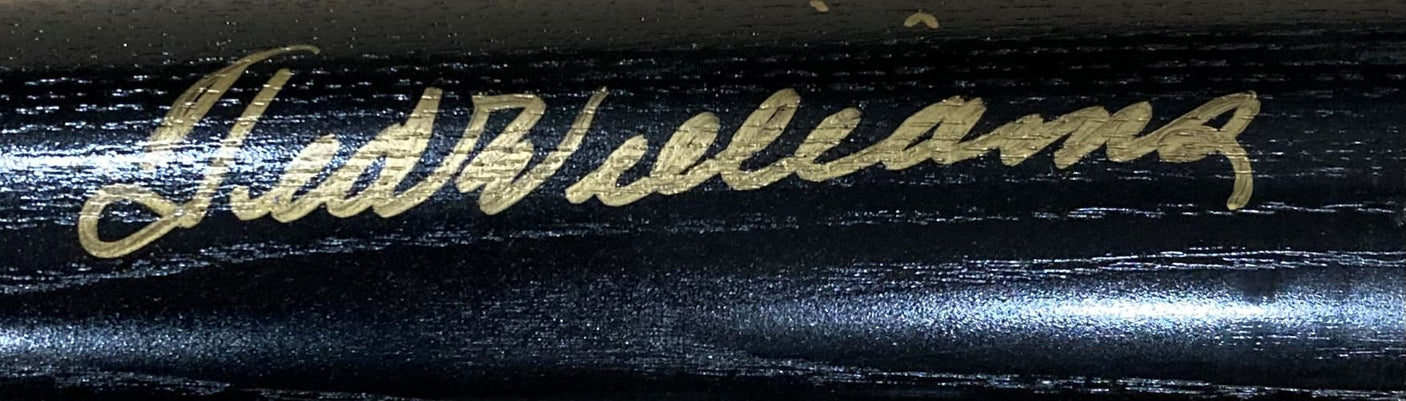 A gold Ted Williams signature appears on the shiny, dark wood of a Sports Integrity Boston Red Sox LS Legend Of The Kid Bat LE/1000, authenticated by PSA/DNA LOA.
