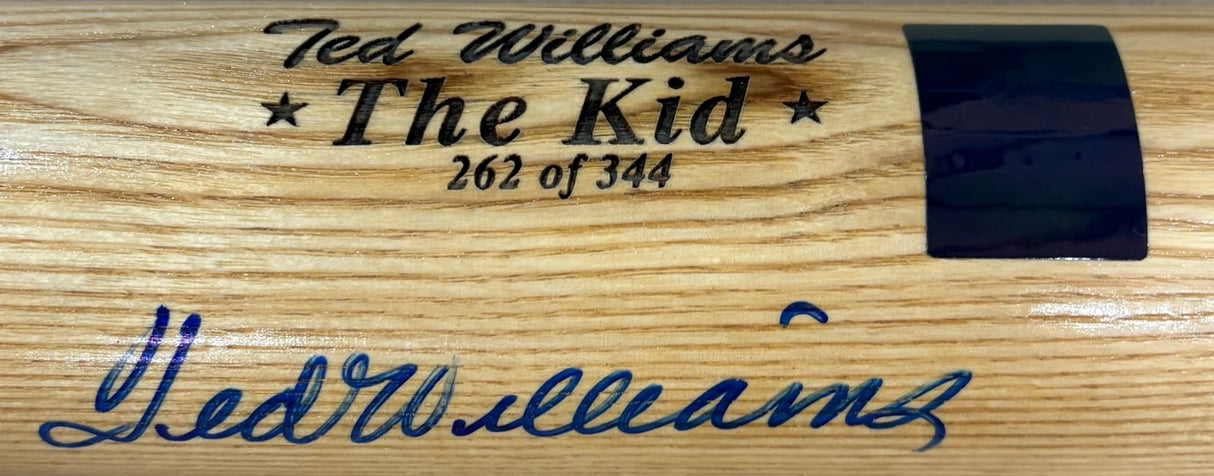 A close-up of a Sports Integrity Ted Williams Boston Red Sox Signed LS The Kid Bat LE/344, engraved "The Kid 262 of 344" and featuring Ted Williams' blue ink signature below the engraving. PSA/DNA LOA included.