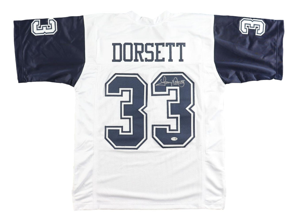 The Sports Integrity Tony Dorsett Dallas Signed Alternate White Football Jersey features navy sleeves, "DORSETT" and number 33 on the back, plus a signature above the number and a JSA QR hologram.