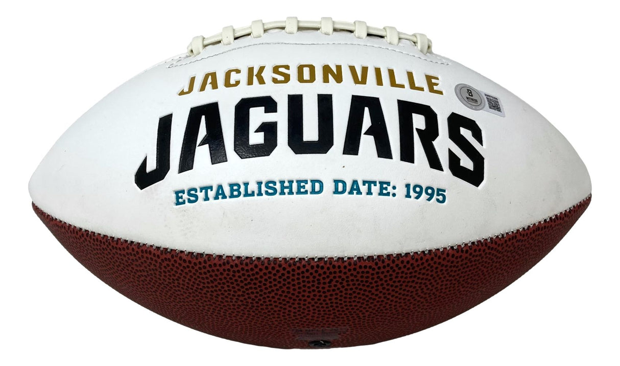 A Travis Hunter signed Jacksonville Jaguars logo football by Sports Integrity, featuring white and brown panels with team name and "Established Date: 1995" in gold, black, and teal lettering.
