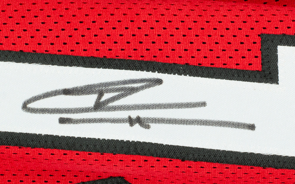 A close-up of the Tyler Herro Miami Signed Red Basketball Jersey by Sports Integrity, showing a bold black autograph on the white section with black trim; a JSA-authenticated collectible for fans.