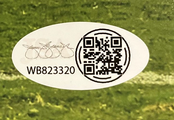 An oval sticker on grass displays a black QR code, serial number WB823320, and an overlapping signature with 0000 loops on the left side for the Tyler Warren Signed 8x10 Penn State Nittany Lions vs USC Photo by Sports Integrity.