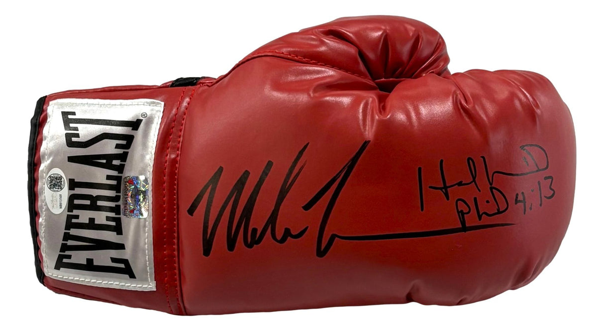 A Sports Integrity Mike Tyson Evander Holyfield signed red Everlast right-hand boxing glove (JSA), featuring a white and black label, two black marker autographs, and a Bible verse reference.
