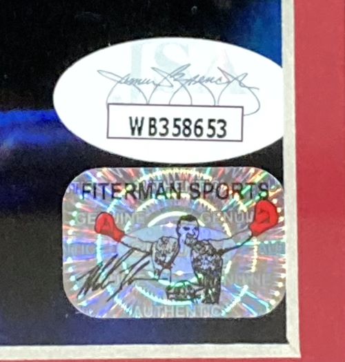 Close-up of two authentication stickers on the Sports Integrity Mike Tyson Left Signed Framed 16x20 Boxing Stare Photo JSA—an oval with signature/code "WB358653," and a holographic "FITTERMAN SPORTS" sticker featuring a red-gloved boxer.