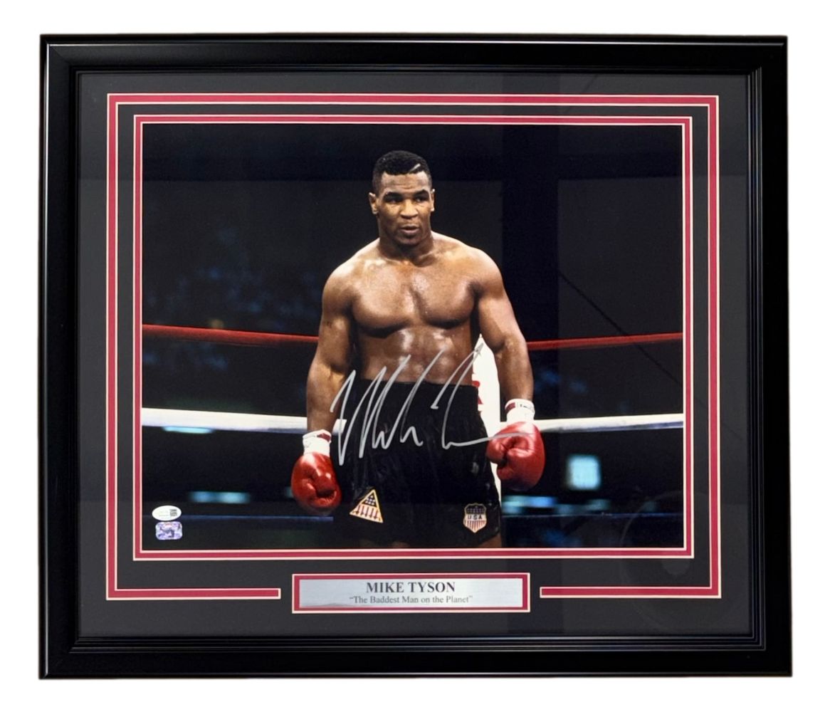 This Sports Integrity framed 16x20 photo features Mike Tyson shirtless in the ring with red gloves, hand-signed and authenticated by a JSA QR hologram. Plaque reads: Mike Tyson "The Baddest Man on the Planet.