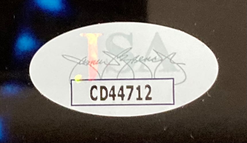 A Sports Integrity oval sticker with JSA text and two signatures appears on the Uma Thurman Signed Framed 8x10 Batman & Robin Poison Ivy Photo, showing code CD44712 in bold black inside a rectangle.