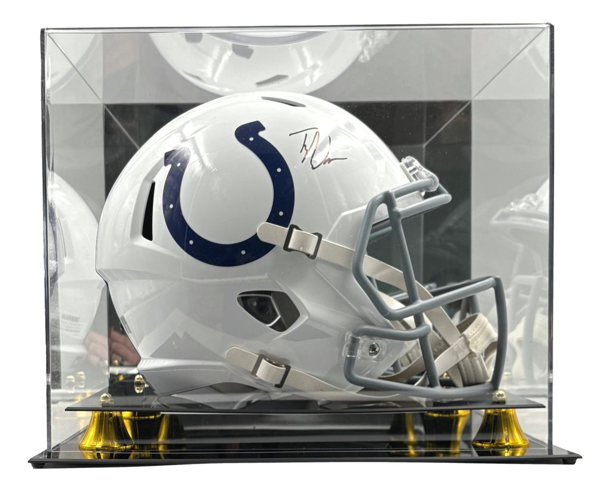 The Sports Integrity Tyler Warren Signed Indianapolis Colts FS Speed Replica Helmet, featuring a blue horseshoe logo, is showcased in a clear acrylic case with a black and gold base.