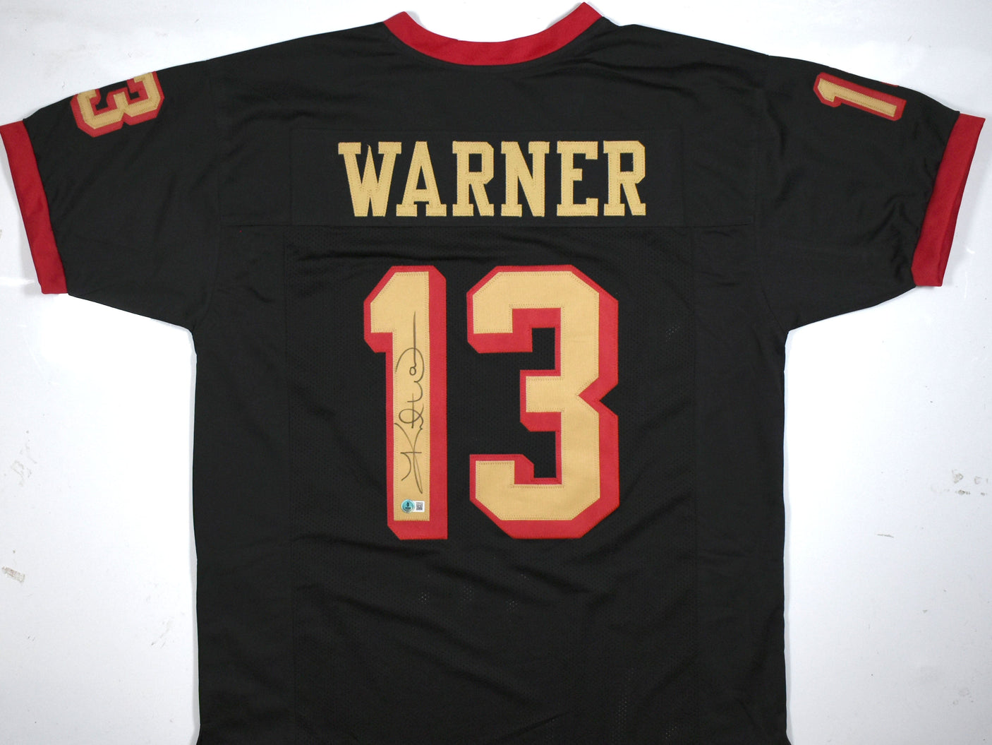 Kurt Warner Autographed Black Pro Style Jersey-Beckett W Hologram *Black