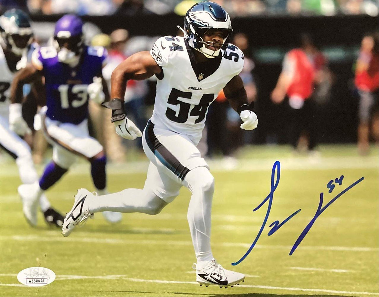 The Sports Integrity Jeremiah Trotter Jr Signed 8x10 Philadelphia Eagles Photo (JSA) shows Trotter Jr in a white #54 uniform running on the field, with Minnesota Vikings players in the background. Autograph in blue marker.