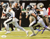The Sports Integrity Jeremiah Trotter Jr Signed 8x10 Philadelphia Eagles Blocking Photo (JSA) shows two players in white uniforms running on the field, with one carrying the ball and an autograph in blue ink.