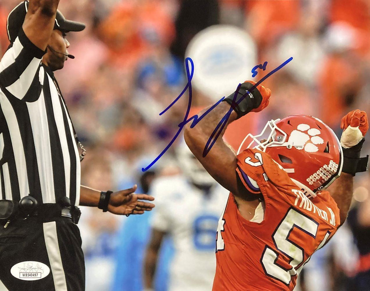 The Sports Integrity Jeremiah Trotter Jr Signed 8x10 Clemson Tigers Photo (JSA) shows Trotter (#54) celebrating in uniform beside a referee, with his autograph in blue ink and a blurred stadium crowd in the background.