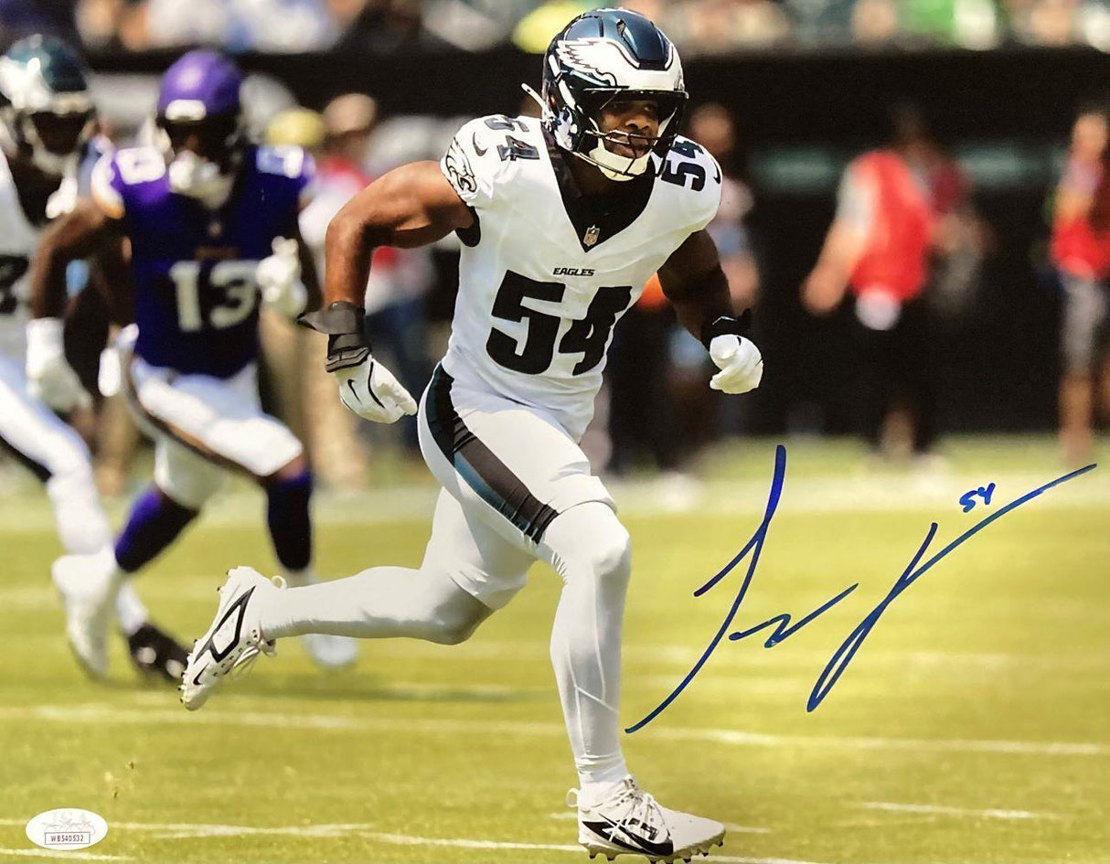 Jeremiah Trotter Jr is pictured in a white Philadelphia Eagles uniform (#54) running on the field against players in purple on this autographed 11x14 photo by Sports Integrity, authenticated by JSA.