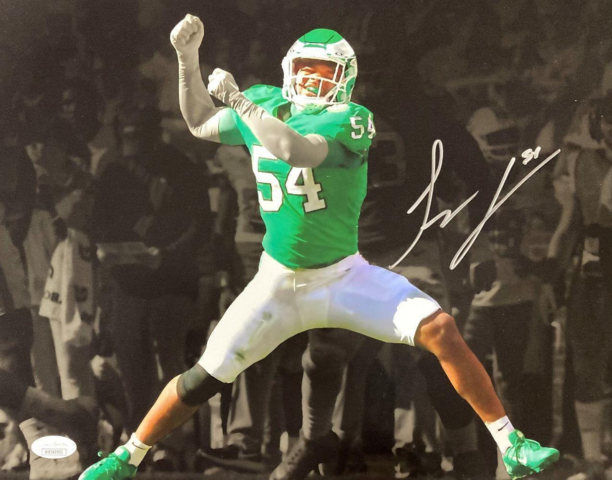 Celebrate with this Sports Integrity 11x14 spotlight photo featuring Jeremiah Trotter Jr. in color, number 54, jumping joyfully in his green and white Eagles uniform. The signed image includes a black-and-white background and JSA authentication.