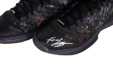 A close-up of the Nike Zoom Kobe III Prelude Shoes, signed by Kobe Bryant, featuring black and purple details. Sold by Sports Integrity.