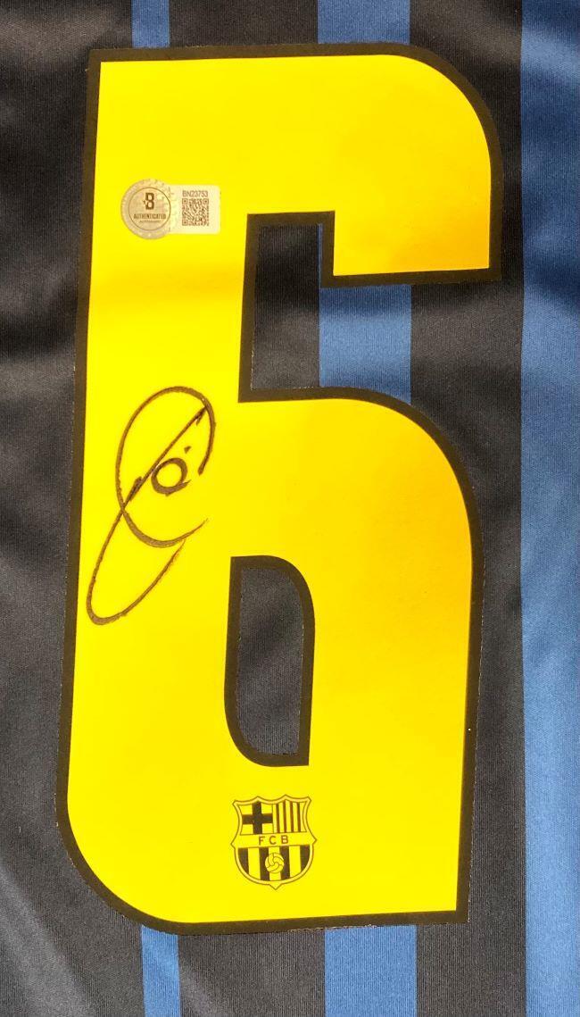 The Sports Integrity Xavi Signed Barcelona Nike Soccer Jersey BAS features a large yellow number 6 on black and blue stripes, a signature, barcode sticker, and a small FC Barcelona crest at the bottom.