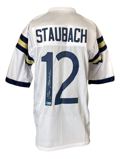 The Sports Integrity Roger Staubach Navy Signed White Football Jersey BAS features blue and gold sleeve stripes, "Staubach" and number 12 on the back, with Staubach’s signature in white ink.