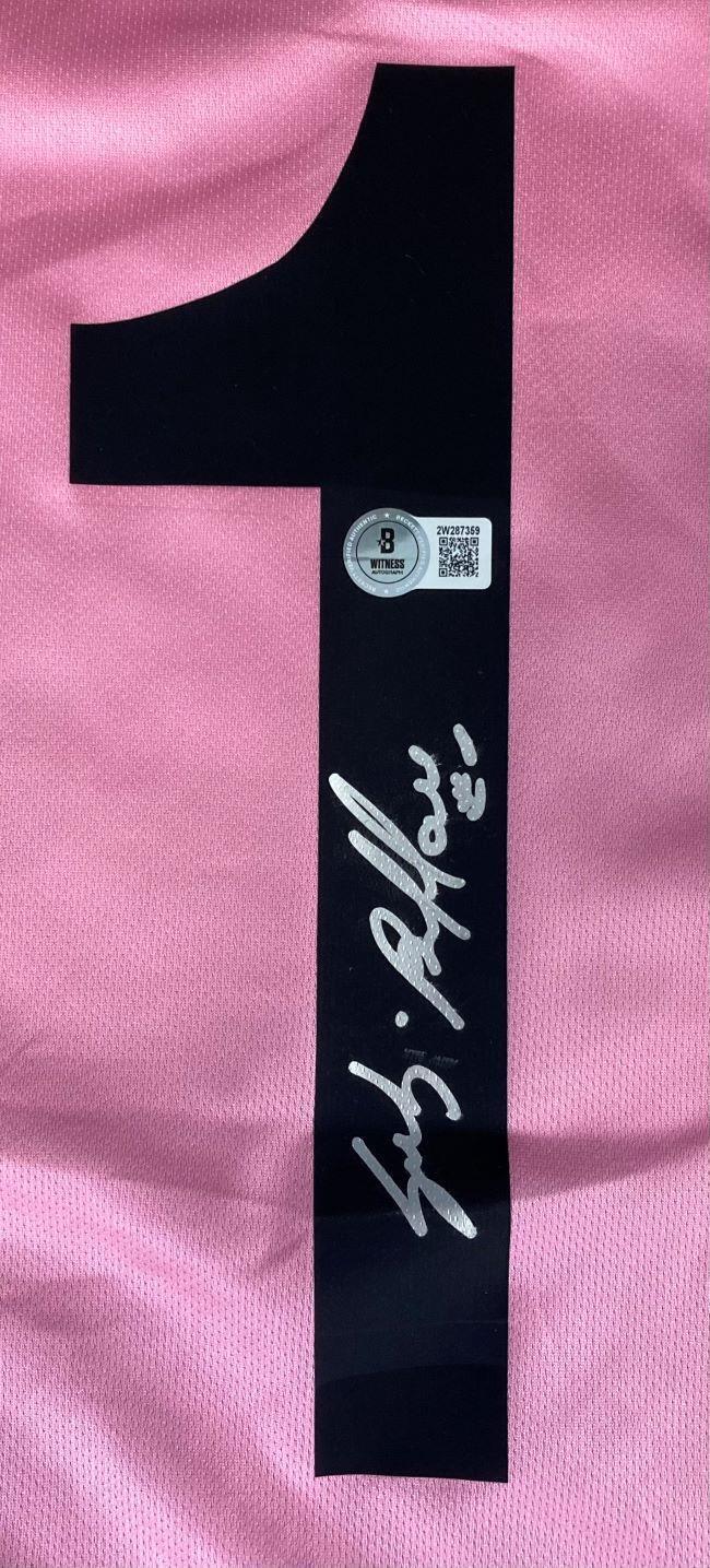 A Gianluigi Buffon Signed Juventus Lotto Pink Soccer Jersey by Sports Integrity features a large black number 1, signed in silver ink with a round BAS authentication sticker displaying a QR code and alphanumeric code above the signature.