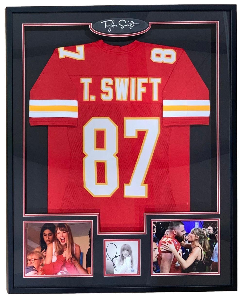 The Sports Integrity Taylor Swift Framed Red Football Jersey w/ Signed Insert PSA/DNA features her No. 87 jersey, signature, and photos of her celebrating at a game and hugging a football player on the field.