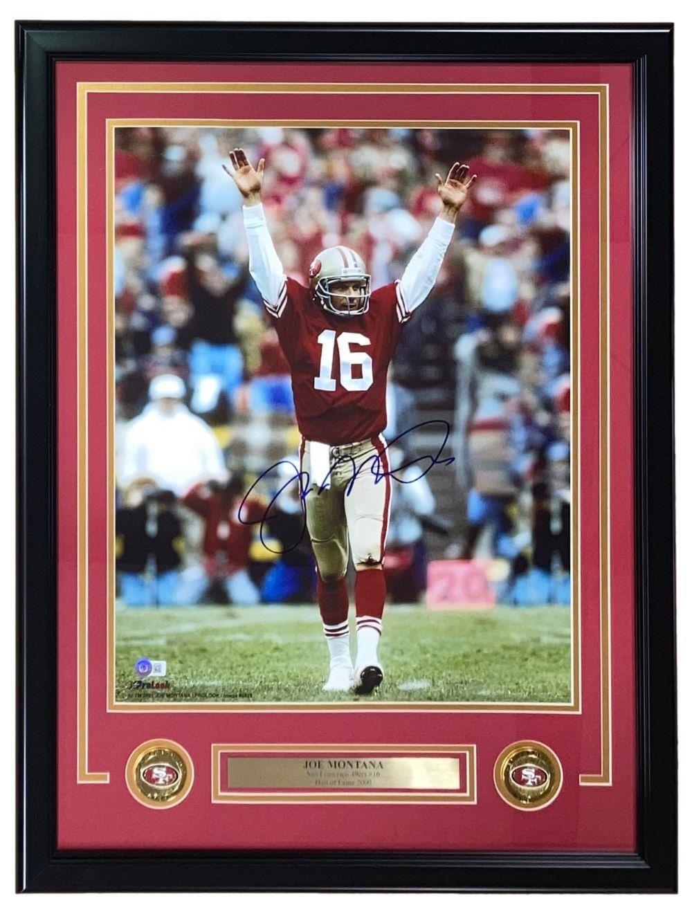 Joe Montana Signed Framed 16x20 San Francisco 49ers Arms Raised Photo by Sports Integrity. Features #16 in red and white, a nameplate, and two small 49ers logos beneath the autographed photo.