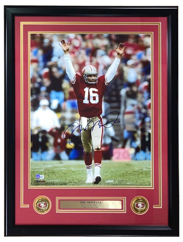 Joe Montana Signed Framed 16x20 San Francisco 49ers Arms Raised Photo by Sports Integrity. Features #16 in red and white, a nameplate, and two small 49ers logos beneath the autographed photo.