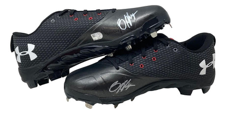 A Bryce Harper signed pair of game-issued Phillies UA cleats by Sports Integrity, featuring white logos and silver autographs on the toes, with one cleat resting atop the other.