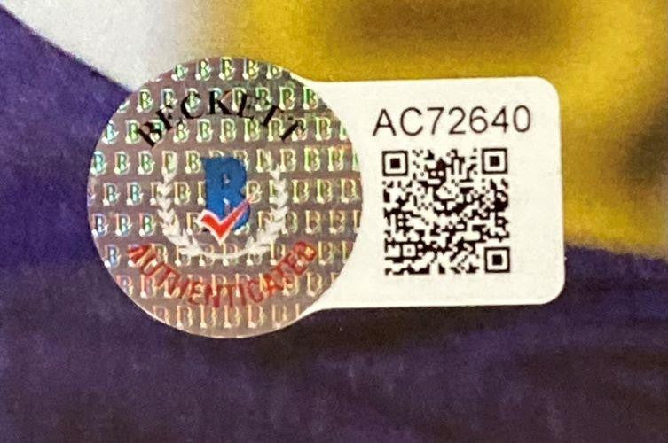 A holographic AUTHENTICATED sticker with a B logo overlays a white label showing AC72640 and a QR code on the Stan Lee Signed Framed 12x18 Marvel Panoramic Photo 2 BAS LOA by Sports Integrity.