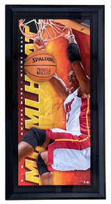 The Dwyane Wade Signed Framed 29x56 Heat Breaking Through Collage by Sports Integrity features Wade dunking in a white and red uniform with vibrant orange and yellow graphics, authenticated with a UDA hologram.