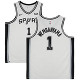 Front and back view of a Victor Wembanyama Signed Spurs White Nike Association Swingman Jersey by Sports Integrity, featuring black trim, number 1, Wembanyama’s name, plus visible Nike and NBA logos.
