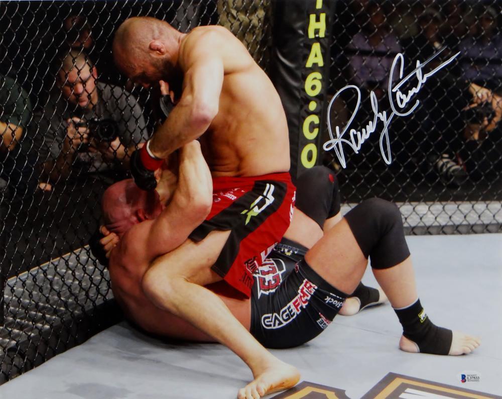 Randy Couture Autographed MMA 16x20 On Top Punching Photo- Beckett Auth *White