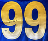 A close-up of the Aaron Donald Signed Los Angeles Rams Blue Nike Limited Jersey by Sports Integrity, showing large yellow 99 numbers with a signature on the left and a BAS ITP authentication sticker near the bottom.