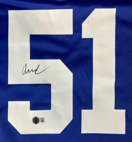 The Abdul Carter Signed New York Giants Nike Game Replica Jersey by Sports Integrity features a large white number 51, a signature on the left side of the “5,” and a black and white authenticity sticker at the bottom of the “5.”.