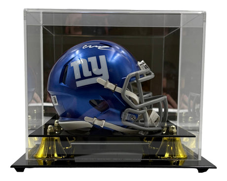 The Abdul Carter Signed New York Giants Mini Speed Helmet by Sports Integrity is displayed in a clear acrylic case with a black base and gold supports.