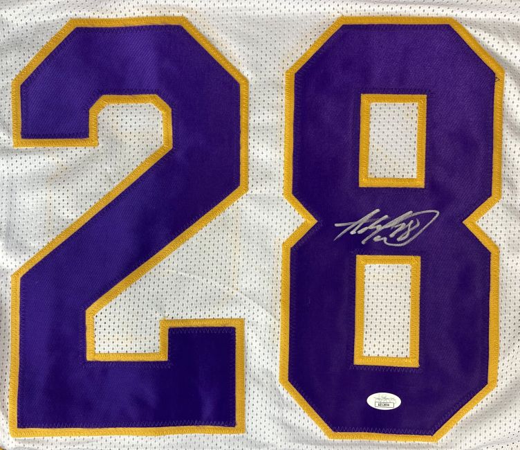 The Sports Integrity Adrian Peterson Minnesota Signed White Football Jersey features large purple and gold number 28, with the number 8 displaying a silver autograph and an authentication sticker at the bottom.