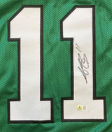 The AJ Brown Philadelphia Kelly Green Football Jersey by Sports Integrity features large white number 11s outlined in black, with one digit displaying a bold black autograph and a round BAS authentication sticker at its base.