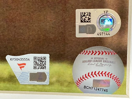 Three authentication stickers, including QR codes and holograms, are attached to a glass case displaying the "Albert Pujols Signed Framed 16x20 St. Louis Cardinals Photo Fanatics" from Sports Integrity.