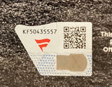 A close-up of a security sticker with a red logo, serial number KF50435557, QR code, and hologram on the Alec Bohm Signed Framed 11x14 Philadelphia Phillies Photo by Sports Integrity.