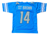 The Sports Integrity Amon-Ra St Brown Detroit Blue Football Jersey features white and silver accents, with "ST BROWN" and the number 14 on the back.