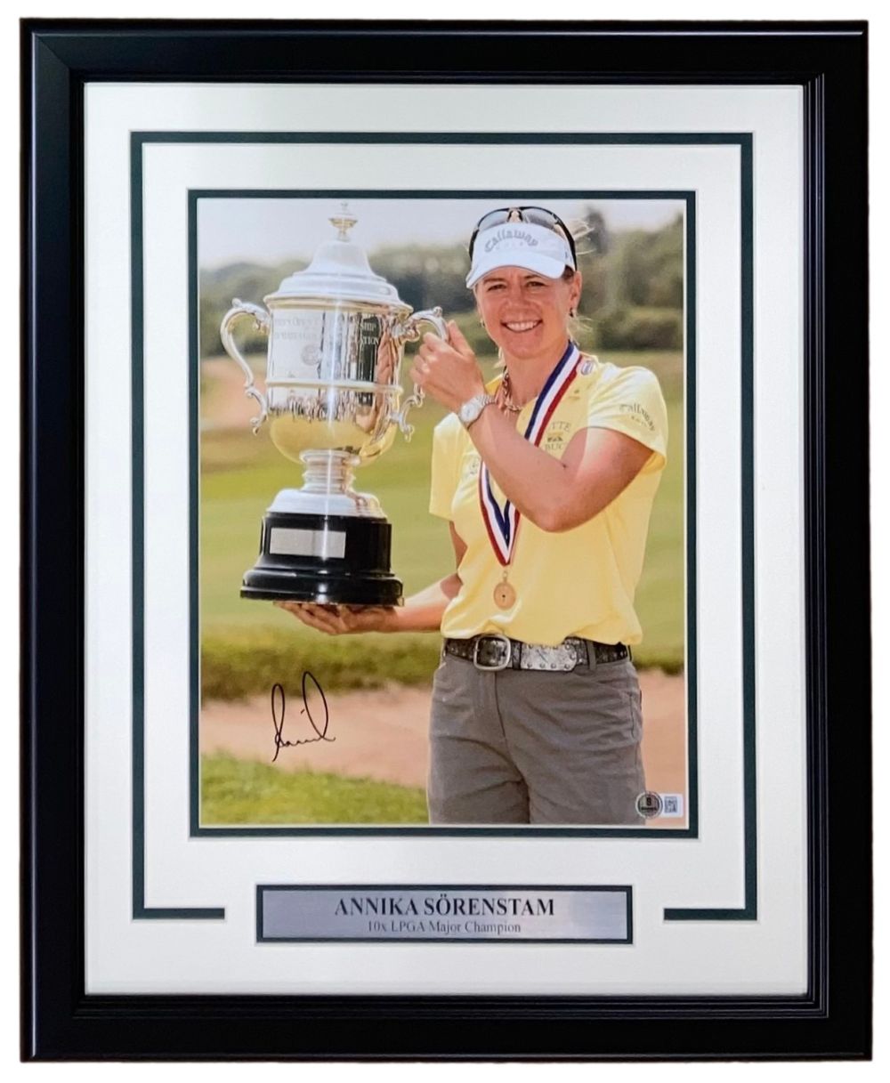 The Sports Integrity Annika Sorenstam Signed Framed 11x14 LPGA Golf Photo (BAS) features Annika smiling in a yellow shirt, medal around her neck, holding a trophy, with a nameplate that reads "Annika Sörenstam, 10x LPGA Major Champion.