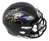The Sports Integrity Anquan Boldin Signed Baltimore Ravens Mini Speed Helmet features a black shell, purple and gold raven logo, white faceguard, and Boldin’s autograph in silver on top.