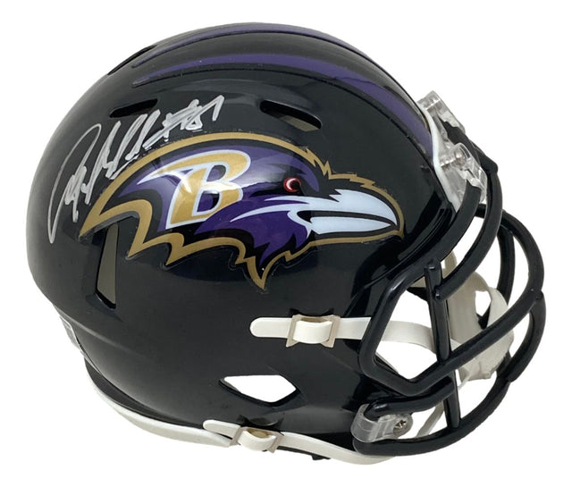 The Sports Integrity Anquan Boldin Signed Baltimore Ravens Mini Speed Helmet features a black shell, purple and gold raven logo, white faceguard, and Boldin’s autograph in silver on top.