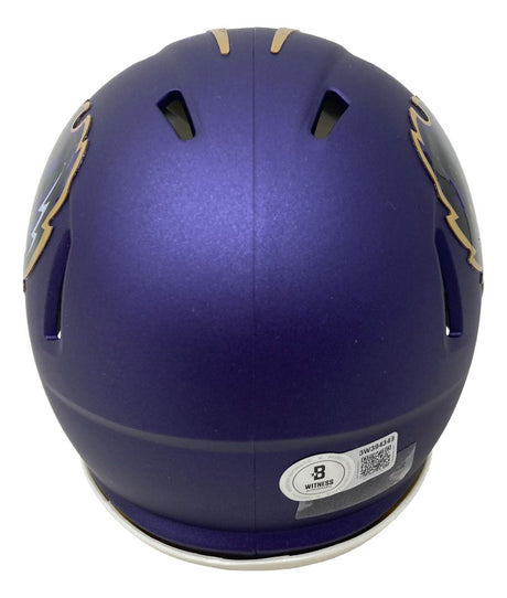 A purple Anquan Boldin Signed Baltimore Ravens Rave Mini Speed Helmet by Sports Integrity, shown from the back with air vents, a white certification sticker with QR code, and partial lightning bolt design on each side.